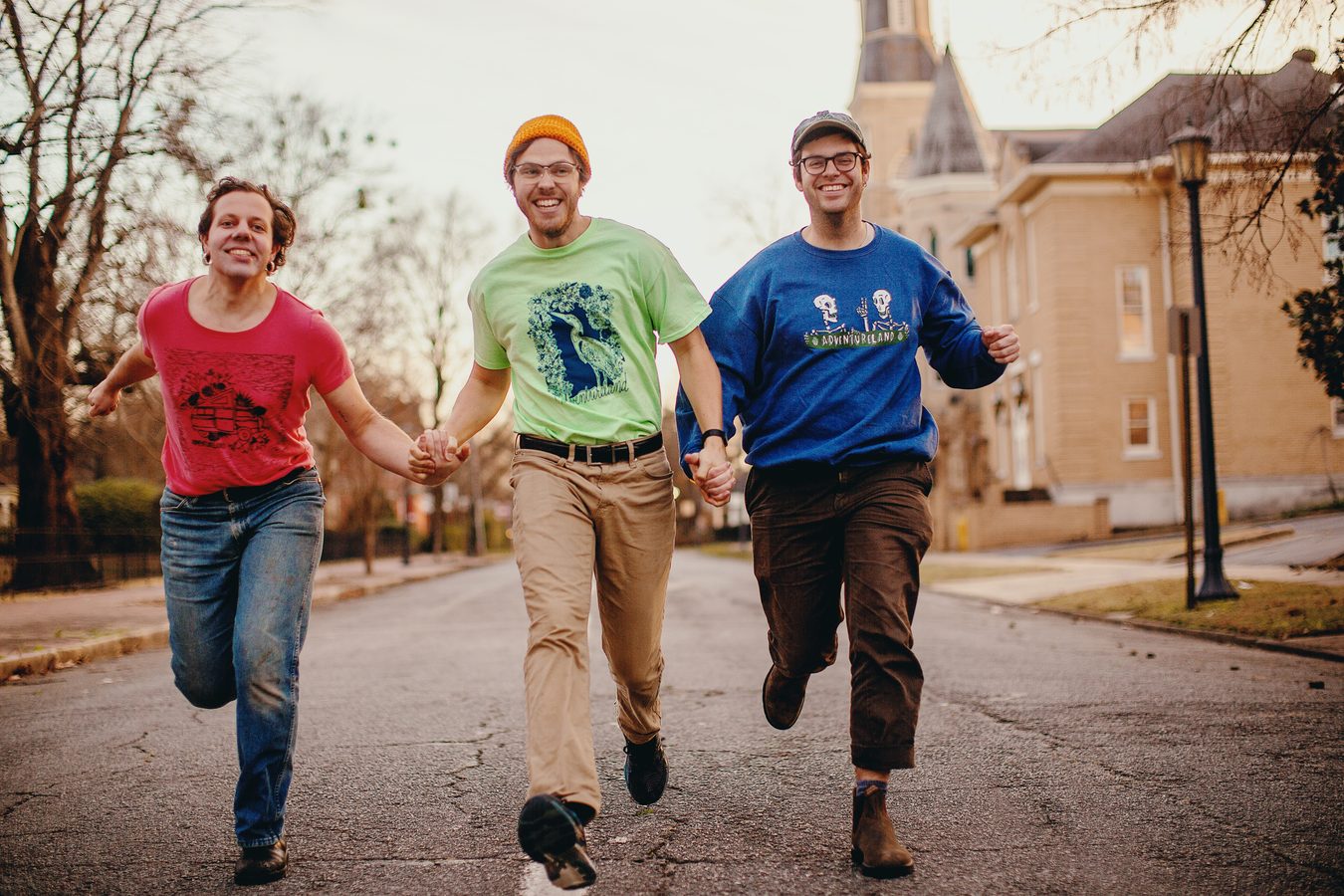 Adventureland running down a street in band merch