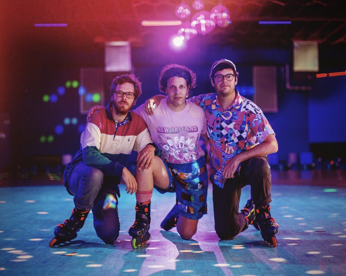 Adventureland kneeling on a roller rink in inline skates